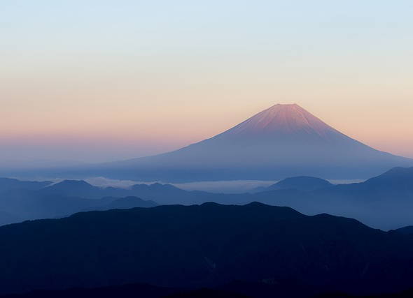 It’s not official yet but Mount Fuji gets its trademark snowcap after the longest delay in 130 years