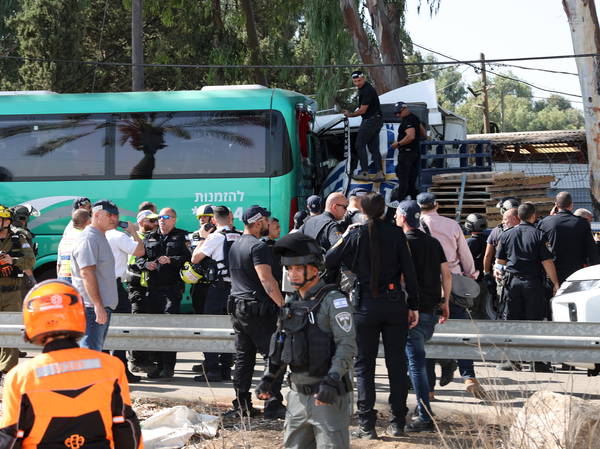 One dead and dozens injured as truck strikes bus stop in central Israel in suspected terror attack