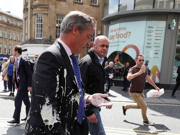 Woman pleads guilty to assault after throwing milkshake at Nigel Farage during election campaign